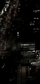 A night view of city traffic from above, showing vibrant city lights.