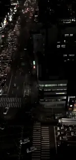 Aerial view of city traffic at night with glowing street lights.