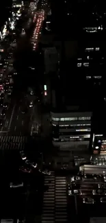 Aerial view of a city street illuminated by night lights.