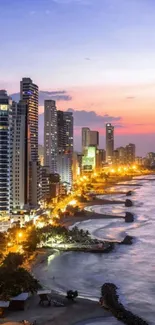 Nighttime cityscape with beach and vibrant skyline glowing at dusk.