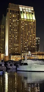 Cityscape marina at night with illuminated buildings and water reflections.