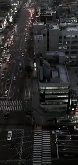 Aerial view of bustling city at night with vibrant lights and traffic.