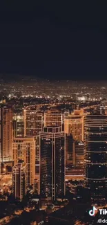 Illuminated urban night skyline wallpaper with skyscrapers.