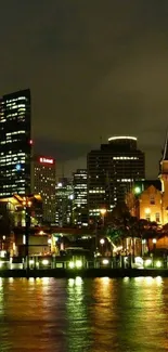 Vibrant night cityscape reflecting on calm water with illuminated buildings.