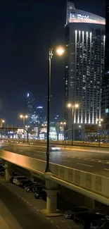 Nighttime urban cityscape wallpaper with illuminated buildings and street lights.