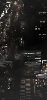 Aerial view of city streets at night with bright lights.