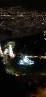 Nighttime cityscape with illuminated landmark and bright lights.