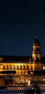 A beautifully illuminated historic building under a starry night sky.