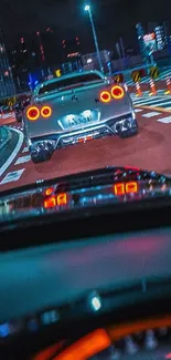 Nighttime city driving scene with cars and vibrant urban lights.