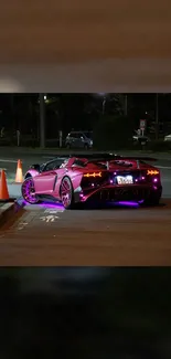 Supercar with vibrant neon lights at night on a city road.