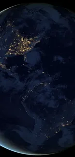 Night view of Earth from space with glowing city lights.