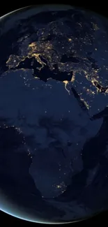 Night view of Earth from space with glowing city lights.