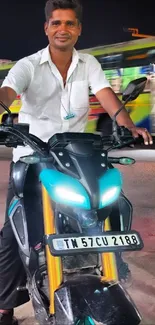 Man on motorcycle in city at night.