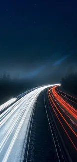 Dark highway with blue and red light trails at night.