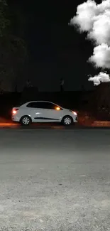 Nighttime parked car by roadside with trees.