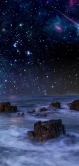 Starry night sky over ocean waves with rocks.