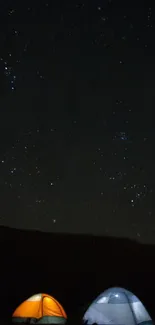 Starry night sky with tents glowing underneath.