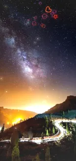 Starry night sky with Milky Way over mountains and winding road.