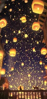 Night sky filled with glowing lanterns over a city, creating a magical view.