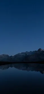 Night sky reflecting on mountains with stars above.