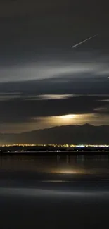 Night sky over a tranquil lake with distant mountains.