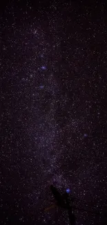 Dark starry night sky wallpaper featuring distant galaxies.