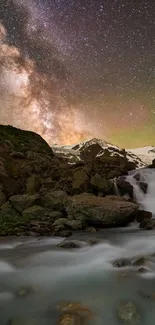 Waterfall beneath a starry night sky with mountains and flowing water.