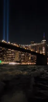 Vibrant cityscape at night with lit skyline and bridge over river.