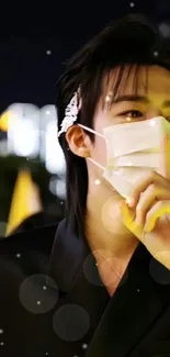 Stylish masked person posing at night with city lights in the background.