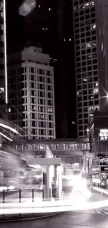 Monochrome cityscape at night with light trails.