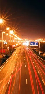 Nighttime city road with light trails and streetlights illuminating the scene.