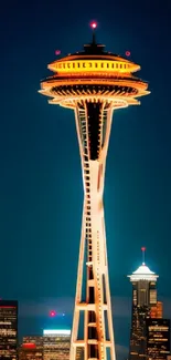 Seattle Space Needle glowing at night with city skyline.