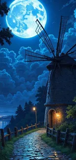 Windmill under full moon with cobblestone path and cloudy sky.