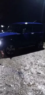 Blue car parked under streetlights at night