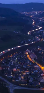 A serene nighttime cityscape with winding roads and glowing urban lights.