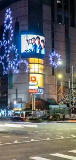 Bright cityscape at night with glowing decorations and light trails.