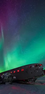 Northern lights over airplane wreck in vibrant green and purple.