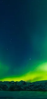 Northern Lights wallpaper with green auroras over mountains.