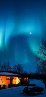 Aurora Borealis over snowy cabin and trees at night.