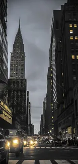 New York City skyline at night with skyscrapers and glowing lights.