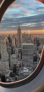 View of NYC skyline during sunset through an airplane window.