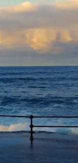 Ocean waves at sunset with golden clouds visible on the horizon.