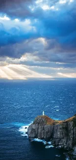 Dramatic sky over ocean with lighthouse on a cliff.