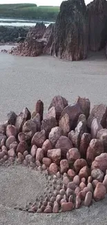 Spiral rock formation art on a sandy beach.