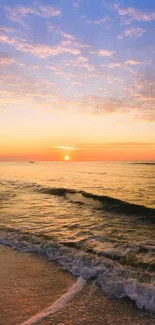 A beautiful sunset over the ocean with waves gently lapping the shore.