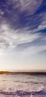 Serene ocean view with sunset sky and waves.