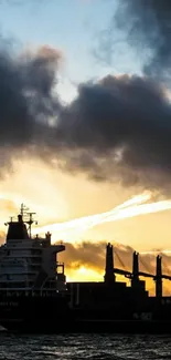 Silhouette of a ship against a vibrant ocean sunset.