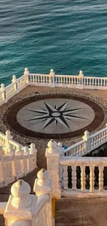 Ocean view balcony with compass design and blue water.