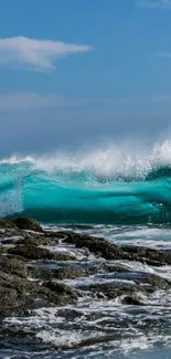 Stunning ocean wave crashing on rocky coastline under a clear blue sky.