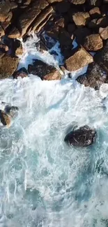 Aerial view of ocean waves crashing against rocky coastline for mobile wallpaper.